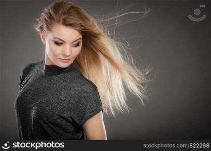 Charm and flirt concept. Lovely charming lady portrait with flirting eye looking and smile. Joyful happy young blonde woman model.. Smiling joyful lady in trendy fashion look.