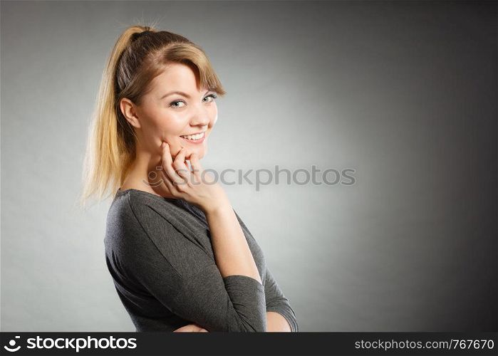 Charm and gladness. Blonde lovely girl in grey smiling. Happy glad charming female portrait.. Happy lovely girl in grey.