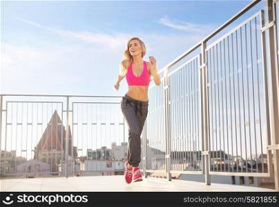 Charming, athletic lady running on the roof