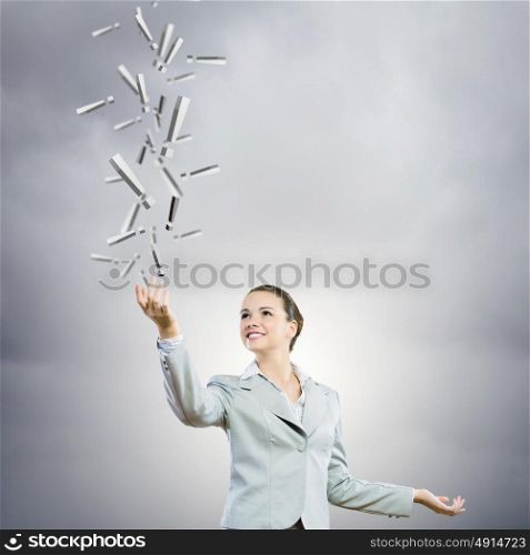 Charming businesswoman. Image of businesswoman holding exclamation marks in hand