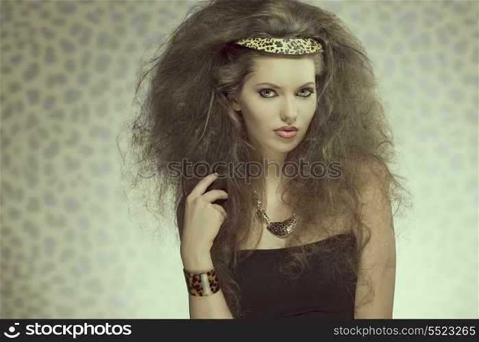charming fashion brunette lady with long curly brown hair-style, pretty make-up and leopard accessories and necklace.