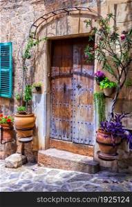 Charming floral streets with old doors and windows. Mediterranean culture and traditional villages