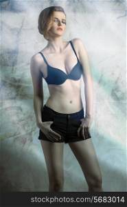 charming girl with fashion hair-style wearing sexy black bra and shorts, in sensual pose. color effect