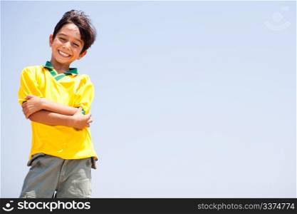 Charming kid posing with folded arms, smiling at camera