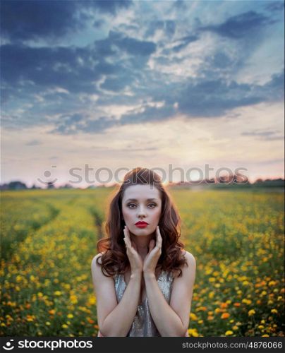 Charming lady among wild-flowers fields