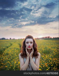 Charming lady among wild-flowers fields