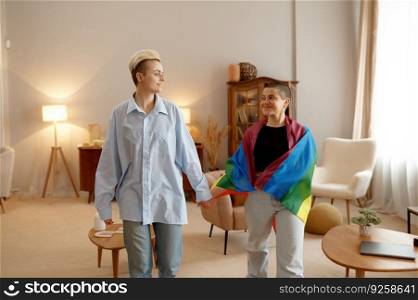Charming lesbian woman couple with rainbow flag sharing loving time with fun feeling warmth and happiness. Charming lesbian woman couple with rainbow flag sharing loving time with fun