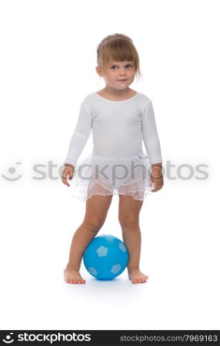 Charming little ballerina with a blue ball in the studio. Isolate on white.