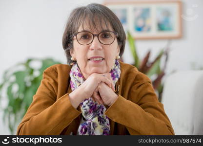 charming mature woman with a brown jacket and glasses