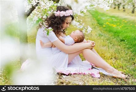 Charming mum playing with little daughter