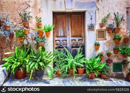 Charming old streets decorated by flowers. Mediterranean culture and traditional villages