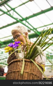 Charming senior woman buying fresh flowers on market