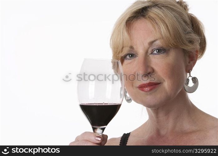 Charming Senior Woman Holding A Glass Of Red Wine