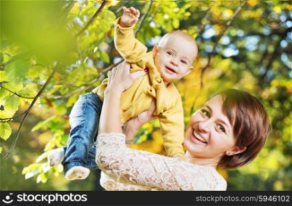 Charming wife carrying little kid