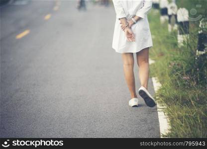 Charming Woman Walking on the road