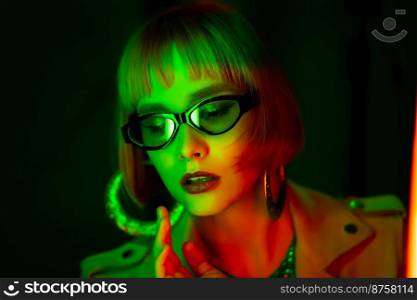 Charming woman with dyed green hair posing under neon light. Unusual mysterious lady in sunglasses, nightlife concept. Modern model pop outfit, influencer lifestyle. High quality photo. Charming woman with dyed green hair posing under neon light. Unusual mysterious lady in sunglasses, nightlife concept. Modern model pop outfit, influencer lifestyle.