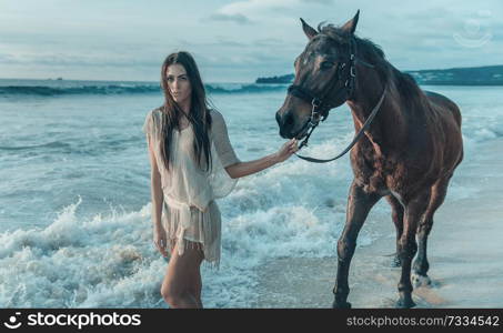 Charming youn glady with a majestic arab horse