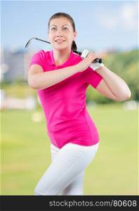charming young athlete with a golf club on a background of golf courses