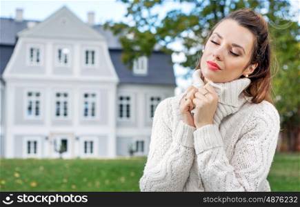 Charming young woman in her autumn garden