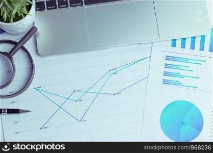 Charts and graphs are placed on the desks, data, and statistical performance of the company in the past year.