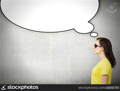 Chat concept. Young woman in casual with blank speech bubble above