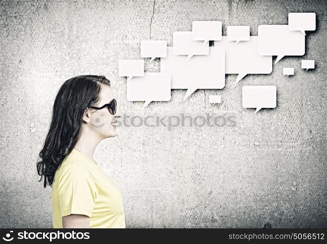 Chat concept. Young woman in casual with blank speech bubble above
