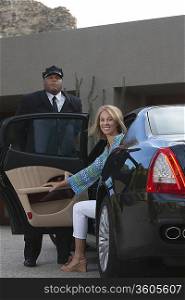 Chauffeur helps woman from luxury vehicle