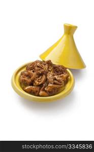 Chebakia, Moroccan honey cookies special for the time of Ramadan in a yellow tajine on white background