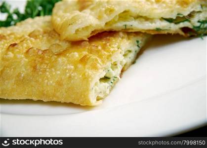 Cheburek with cheese- traditional Caucasian dish.national dish of the Crimean Tatars and Caucasian and Turkic peoples, popular Transcaucasia, Central Asia, Russia, Ukraine, in Turkey and Romania.