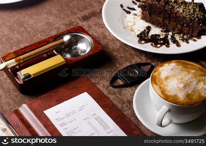 check, ashtray, cigar, lighter and coffee at restaurant table
