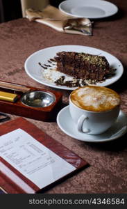 check, ashtray, cigar, lighter and coffee at restaurant table