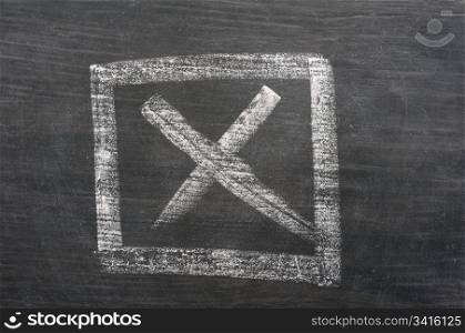 Check box with a cross drawn in chalk on a blackboard