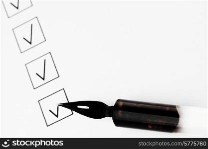 Check boxes and pen isolated on white background. Check boxes and pen