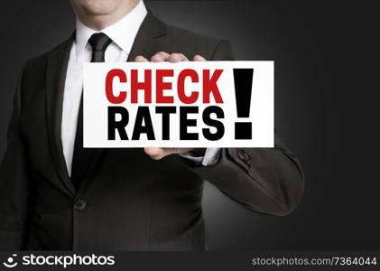Check Rates sign is held by businessman.. Check Rates sign is held by businessman