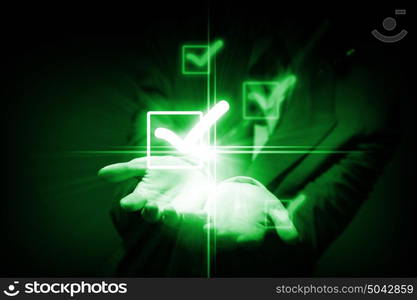 Checkbox tick. Close up of businessman holding icons in palms