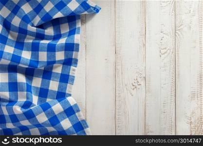 checked cloth napkin on wooden background