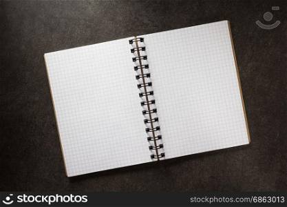 checked notebook on background texture