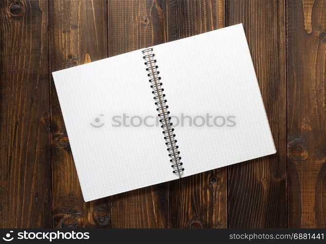 checked notebook on brown wooden background