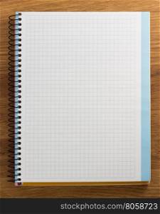 checked notebook on wood background