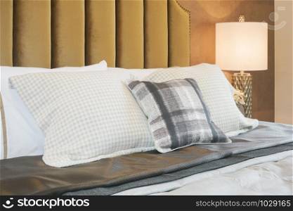 Checked pattern pillows on bed in luxury style interior bedroom
