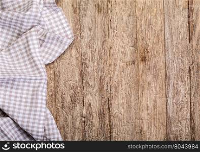 checkered tablecloth on wooden table background