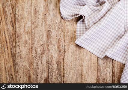 checkered tablecloth on wooden table background