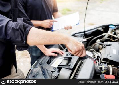 checking vehicle engine at the garage industrial concept, Hands of auto mechanic checking in a car with open hood