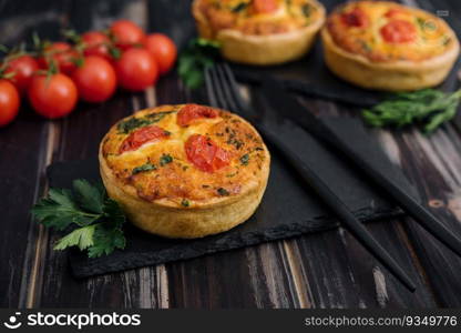 Cheddar cheese and spring onion omelette tarts served on wooden board