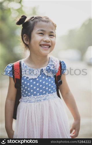 cheerful asian children school pack on back toothy smiling face outdoor
