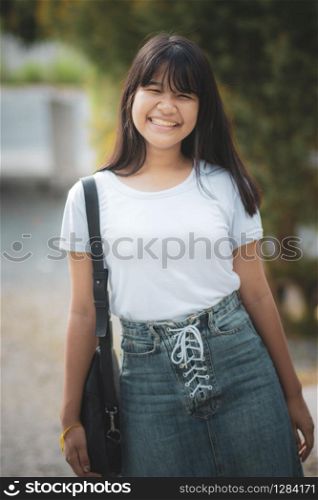cheerful asian teenager relaxing in public park