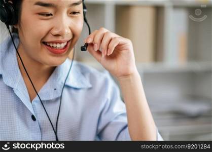 Cheerful Asian woman wear headset smiling and use laptop video call stream conference to working online while during quarantine covid-19 self isolation at home, work from home concept