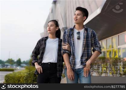 Cheerful Asian young man and woman dating at shopping mall, They talking, smile and laugh together with happiness, New normal lifestyle 