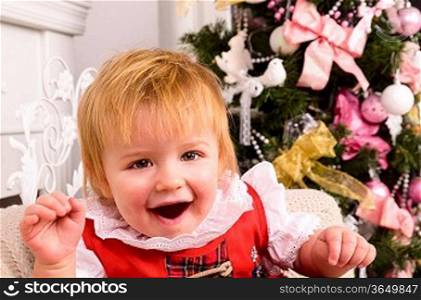 cheerful baby near christmas tree