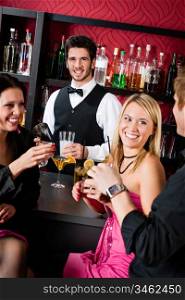 Cheerful barman prepare alcoholic cocktail young friends at the bar